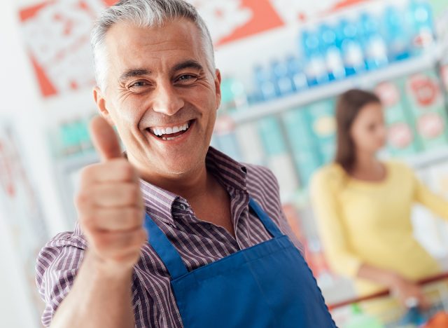 Happy supermarket clerk