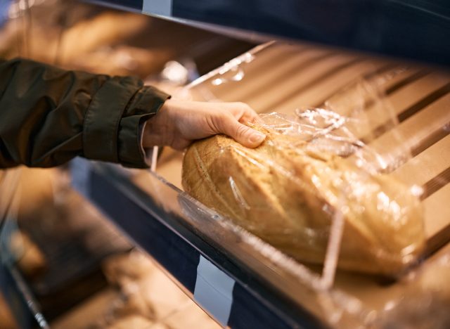 closeup of woman choosing bread at the supermarket