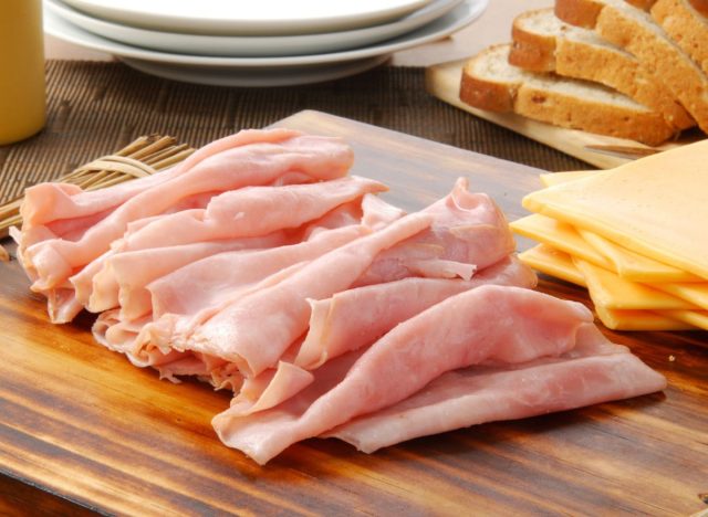 deli meats on charcuterie board next to cheese for sandwiches