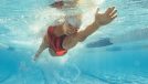 fit woman swimming laps, concept of workouts that burn the most calories