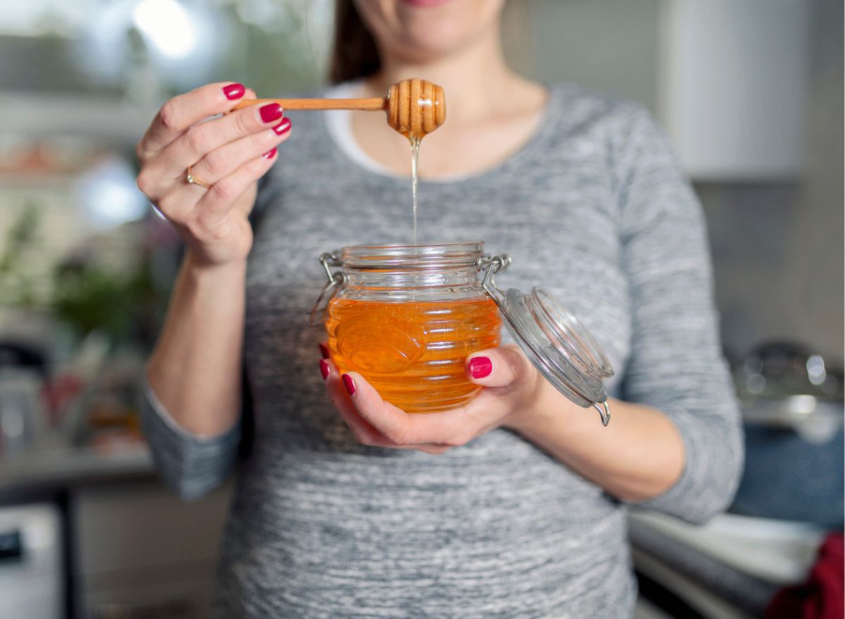 holding a jar of honey