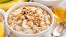 large bowl of oatmeal with bananas and honey, concept of surprising breakfast foods that can destroy your waistline