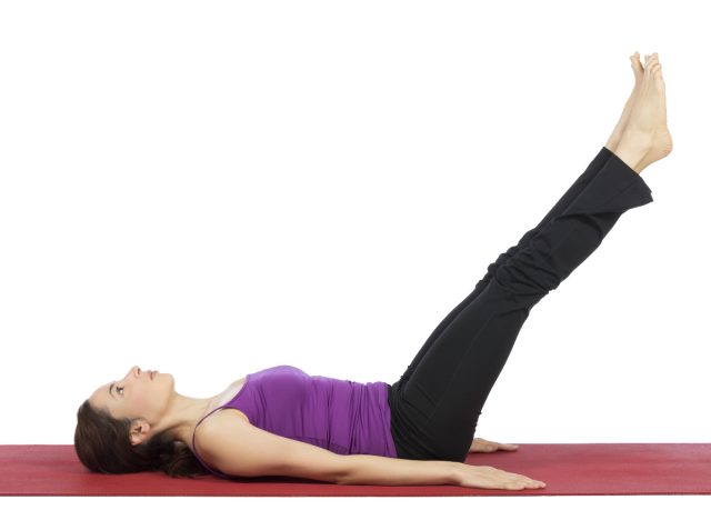 woman doing leg raises floor workout for washboard abs