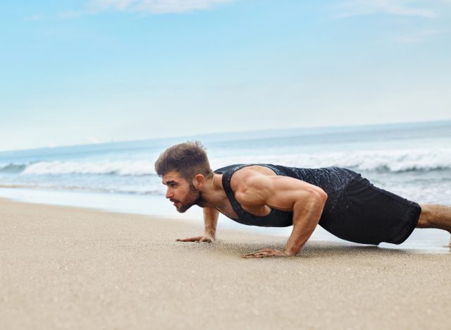 man doing beach pushups, exercises for men to stay fit