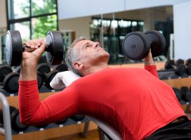 mature man doing dumbbell bench presses, concept of workout for men to stay fit after 50