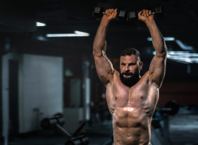 man doing dumbbell overhead presses