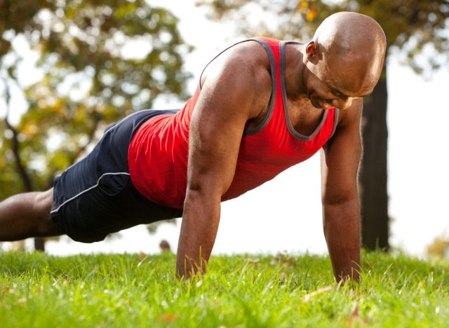 man doing pushups outdoors, concept of workouts to change your body shape