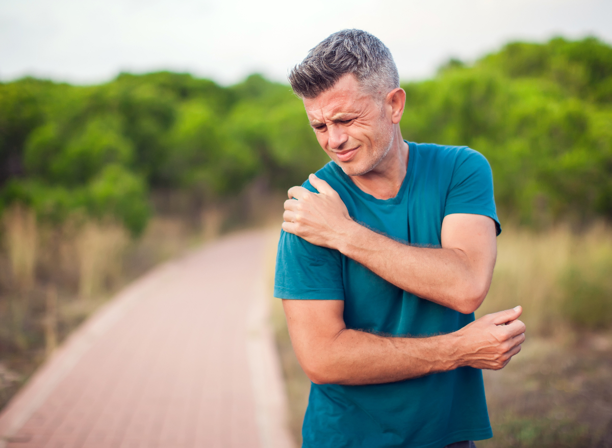 man dealing with shoulder joint pain during walk, concept of worst daily habits for joint health as you age