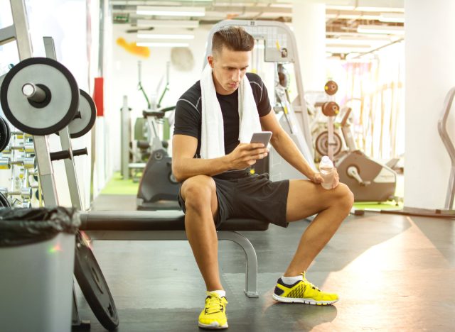 man texting at the gym