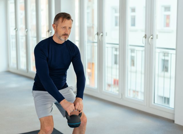 mature man working out with a kettlebell