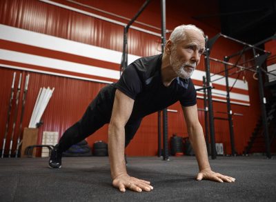 mature man doing pushups, concept of the best exercises to do after 60