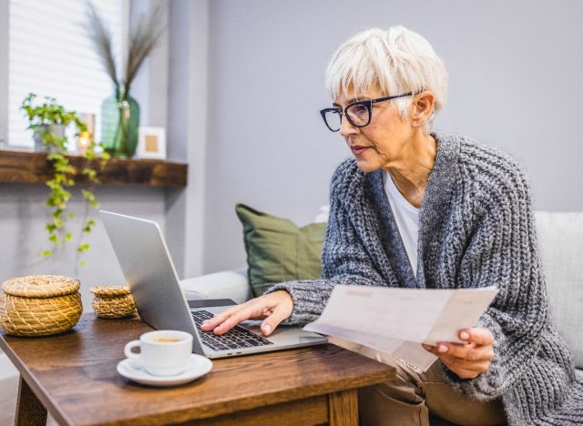 mature woman paying bills