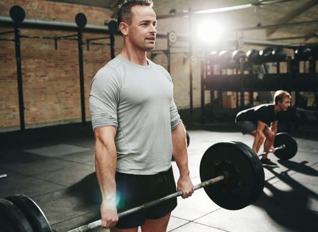 middle-aged man holding barbell, concept of exercises for men to stay fit in their 40s