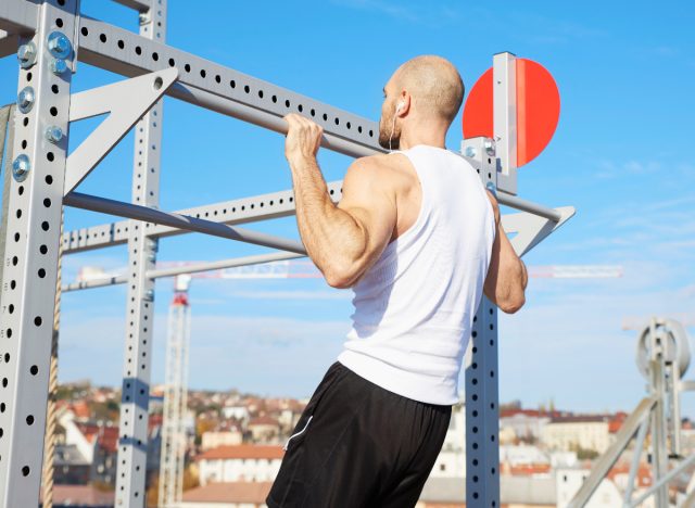 middle-aged man doing pull-ups