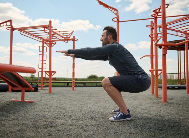middle-aged man doing bodyweight squats