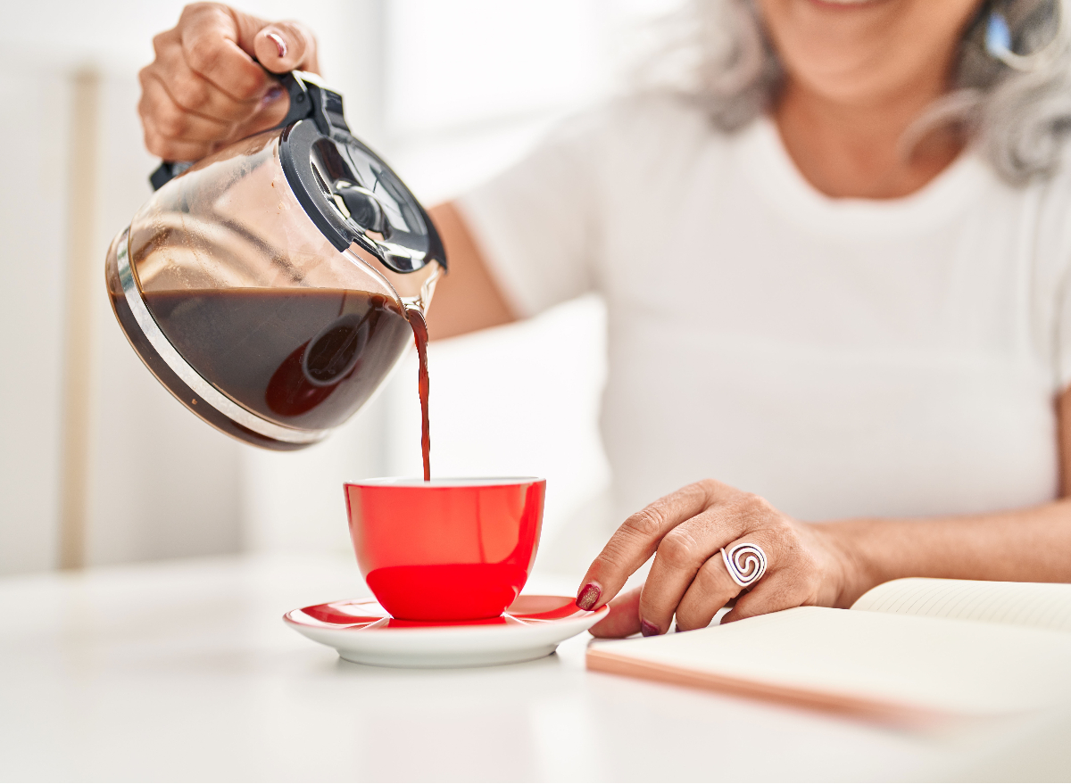 middle-aged woman pouring coffee, concept of tricks to help you poop first thing in the morning