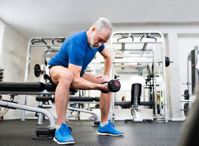 senior man doing dumbbell curls, concept of fitness habits that destroy your body after 60