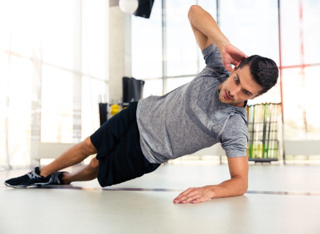 man doing side plank