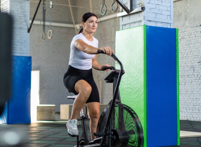 woman on air bike, concept of machines for weight loss