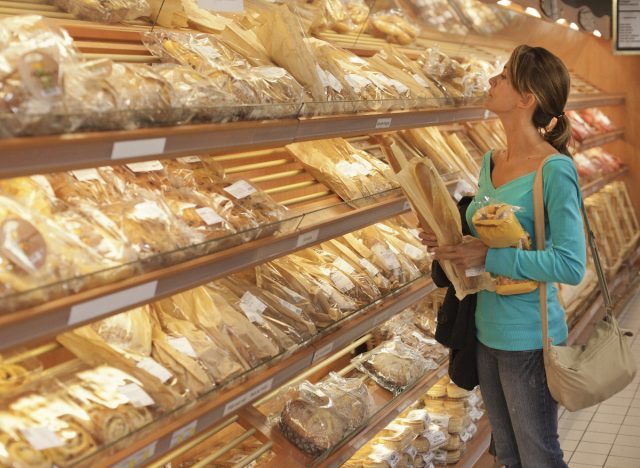 woman choosing bread at the grocery store