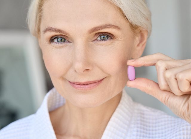 woman holding collagen supplement, concept of best supplements for women over 50