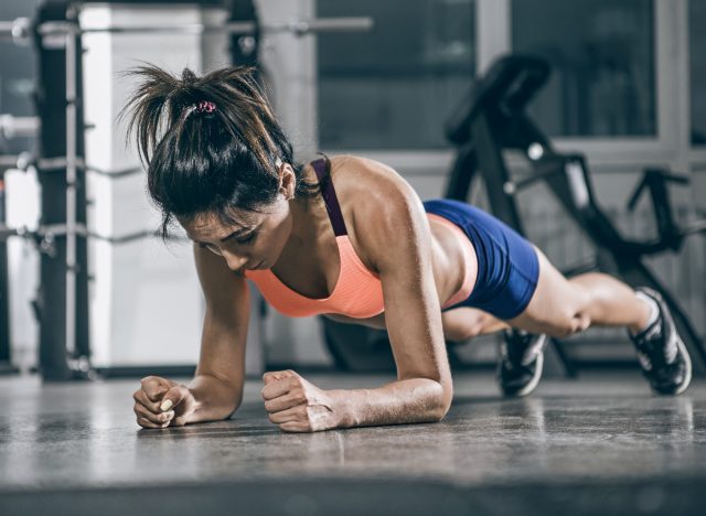 fit woman doing forearm planks