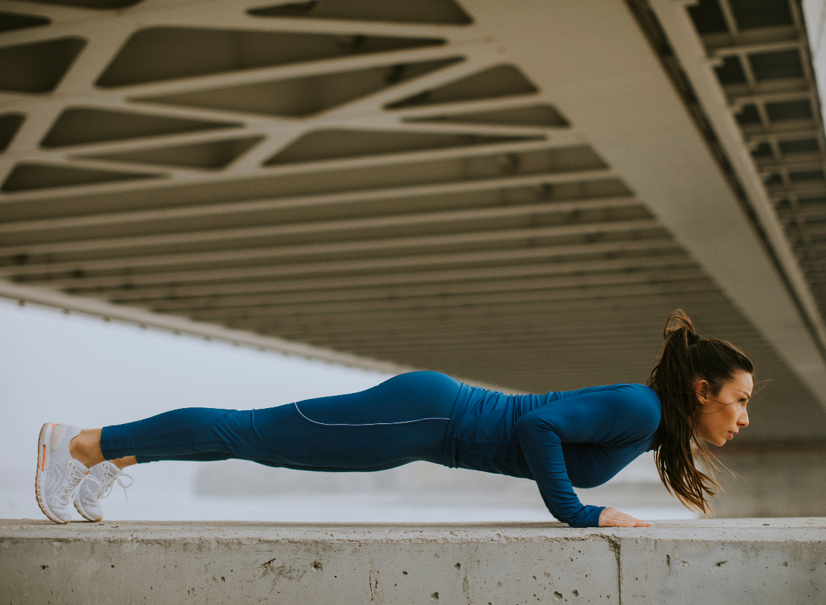 fit woman doing pushups, concept of simple strength exercises for a slim and slender body