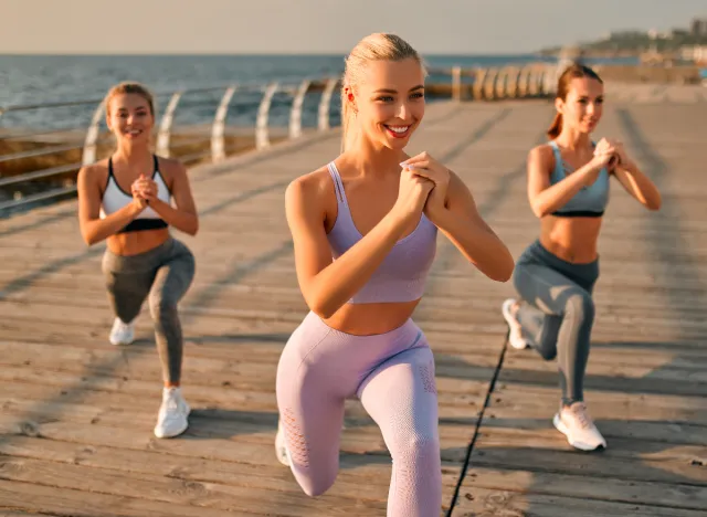 group of women doing walking lunges, concept of no-gym workout for a lean body