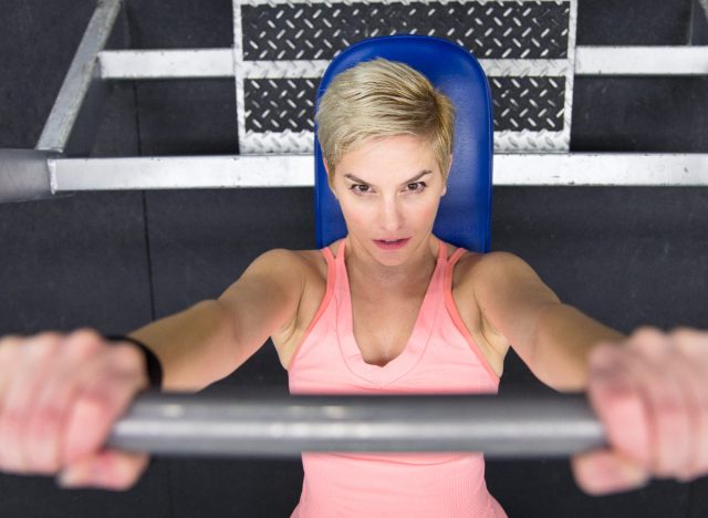 woman doing barbell bench presses