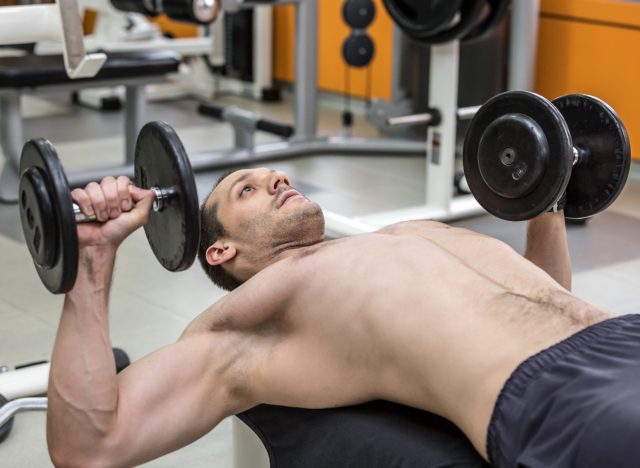 man doing dumbbell bench presses