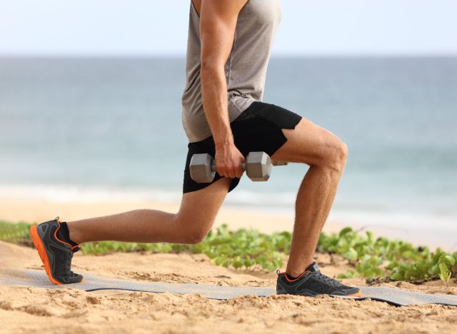 man doing dumbbell lunges