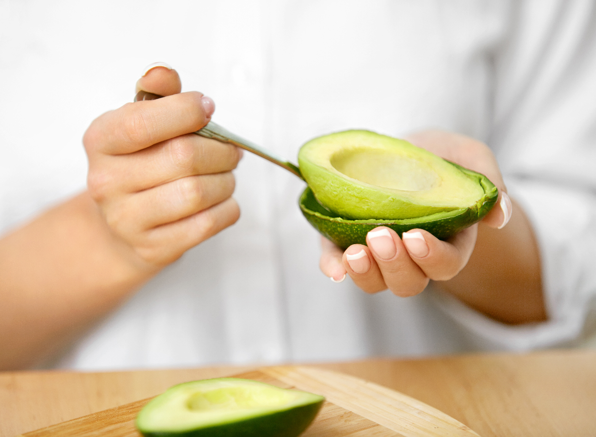close-up scooping out avocado, concept of habits that destroy weight loss