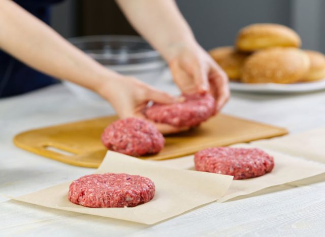 woman forming a hamburger patty