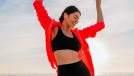 happy fitness woman dancing on beach, concept of daily habits to age well