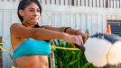 woman doing kettlebell/weighted swings, concept of quick daily exercises to melt body fat
