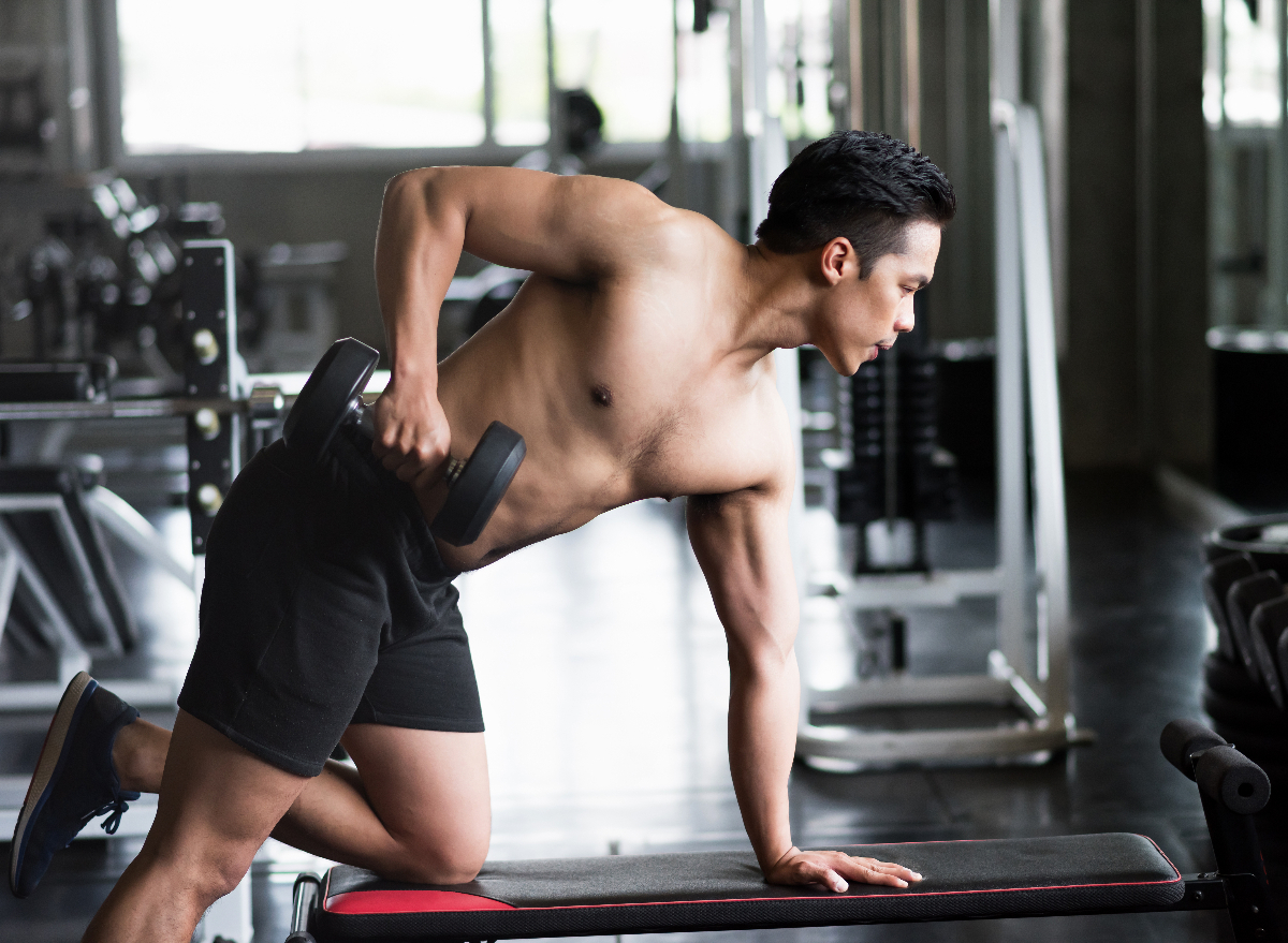 man doing dumbbell rows, exercises for men to gain strength before 40