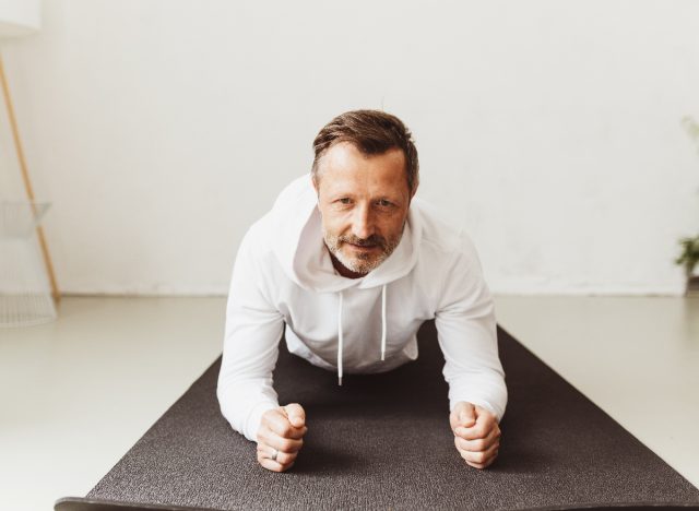 middle-aged man doing planks, concept of exercises for men in their 50s