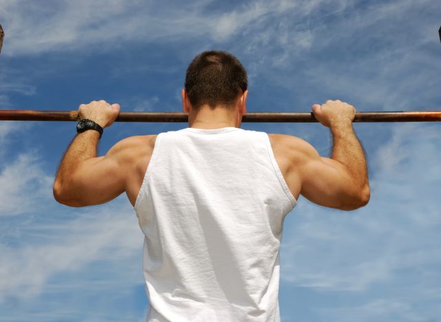 fit man doing pull-ups, concept of strength exercises for men
