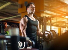 fit man lifting dumbbells, concept of dumbbell exercises for men to gain strength