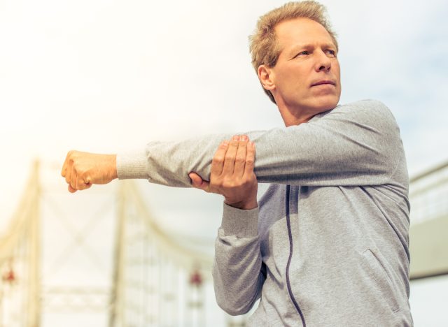 The 7 best fitness habits for men in their 40s - middle-aged man stretching
