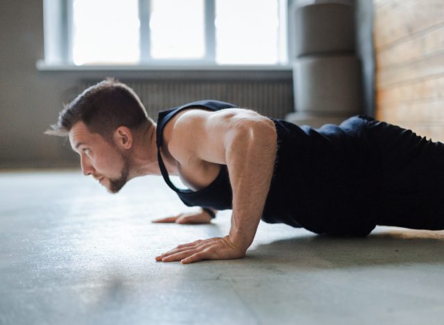 muscular man doing pushups, concept of bodyweight workout for men