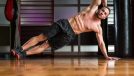 muscular man doing side planks, concept of exercises for your obliques