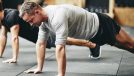 middle-aged man doing pushups, concept of daily floor exercises for men in their 40s