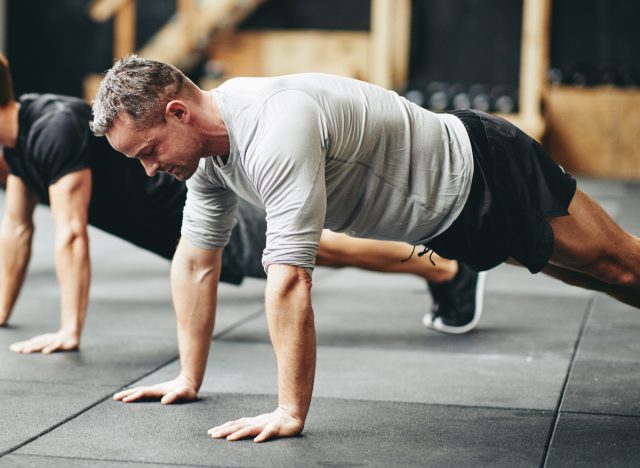 middle-aged man doing pushups, concept of daily floor exercises for men in their 40s