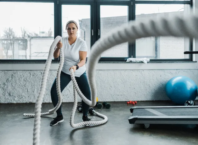 woman training with battle ropes