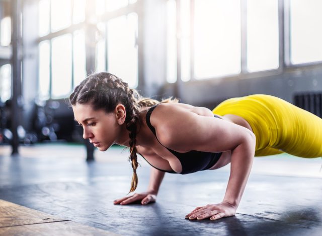 fitness woman doing pushups at the gym