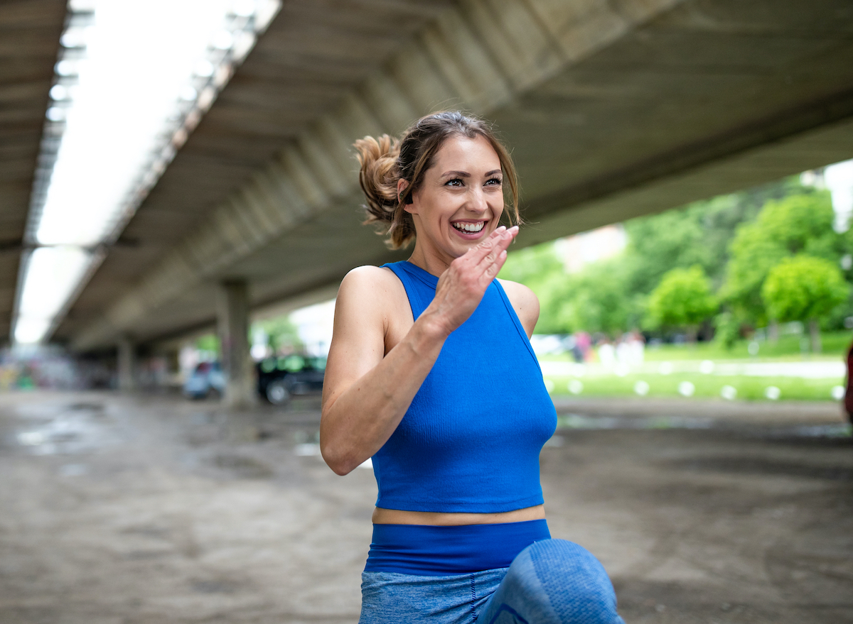 woman doing high knees, workout for faster abdominal fat loss