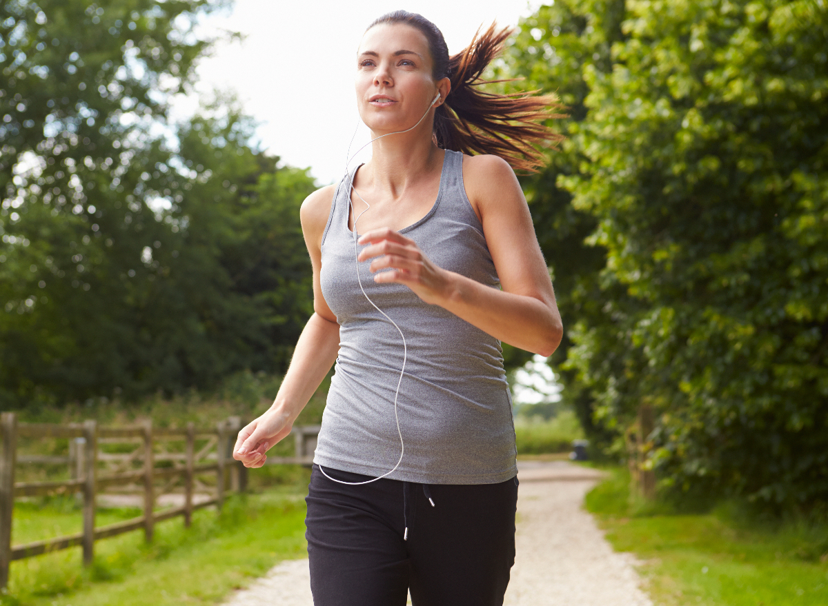 woman running outdoors, concept of ways to lose leg and thigh fat
