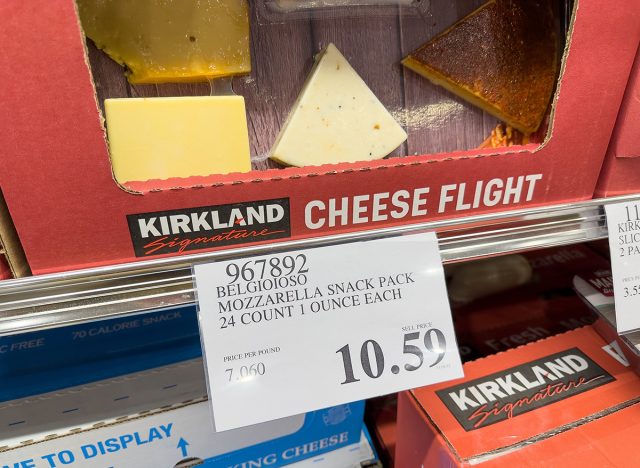 Closeup of a price tag for mozzarella snack pack inside Costco warehouse.