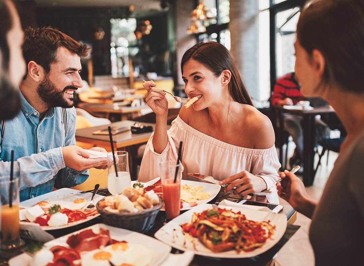 Group of Happy friends having breakfast in the restaurant